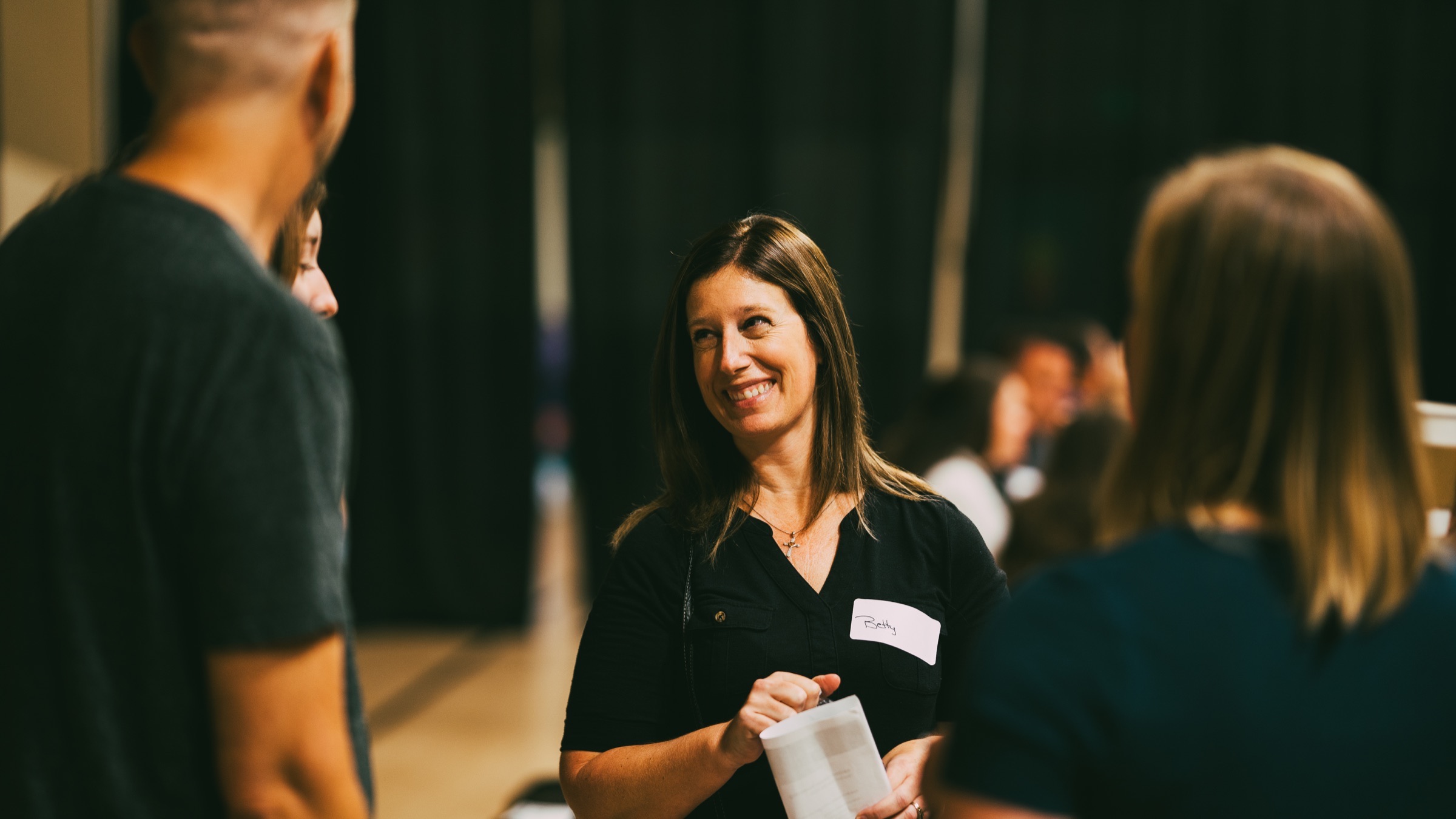 People sharing a meal and conversation at an Orbit dinner party