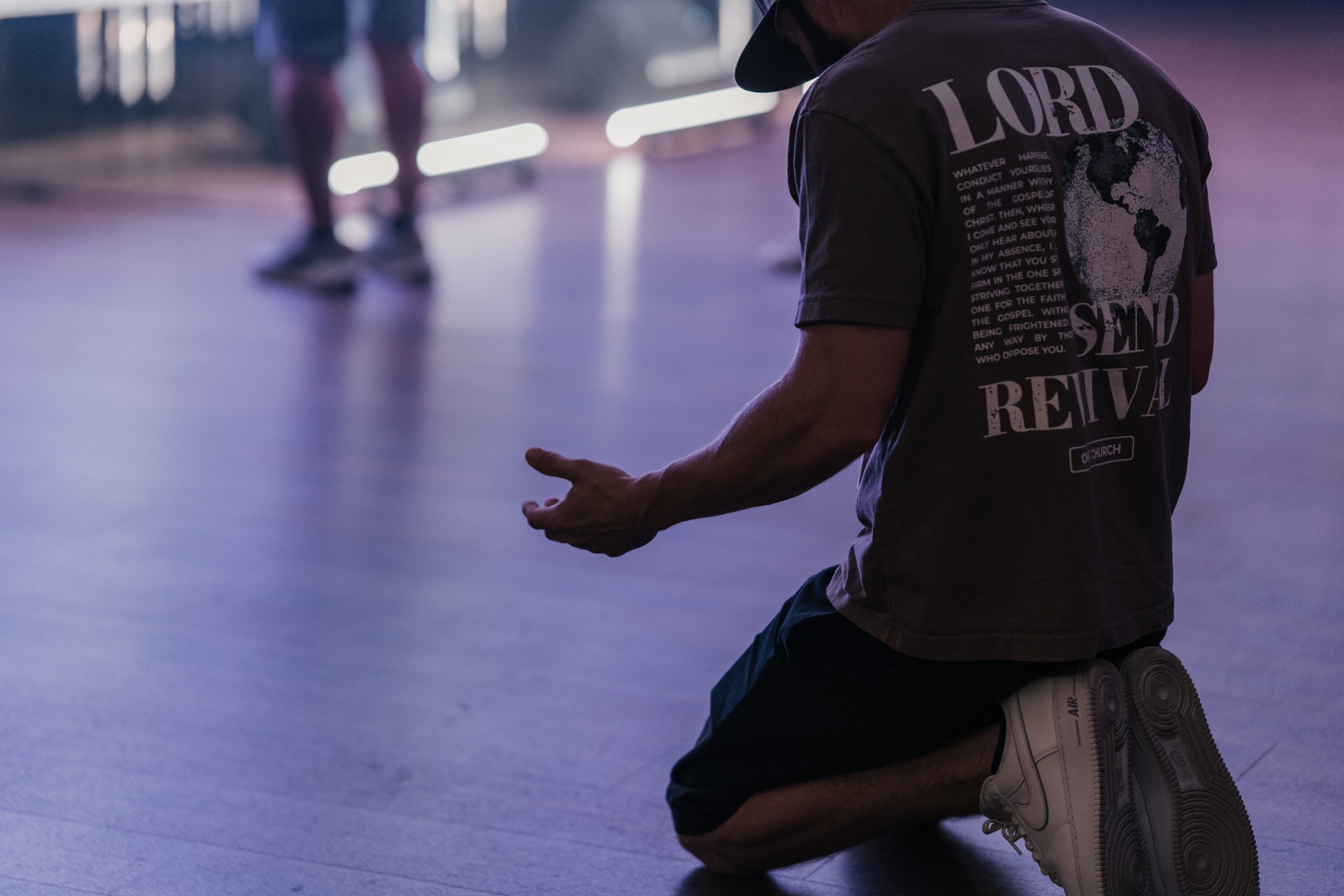 An Orbit person praying during a gathered worship night