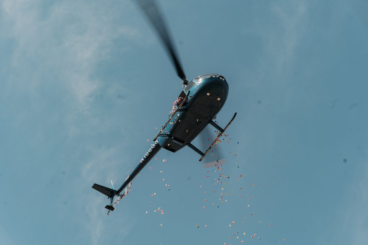 A helicopter dropping thousands of Easter eggs over the field
