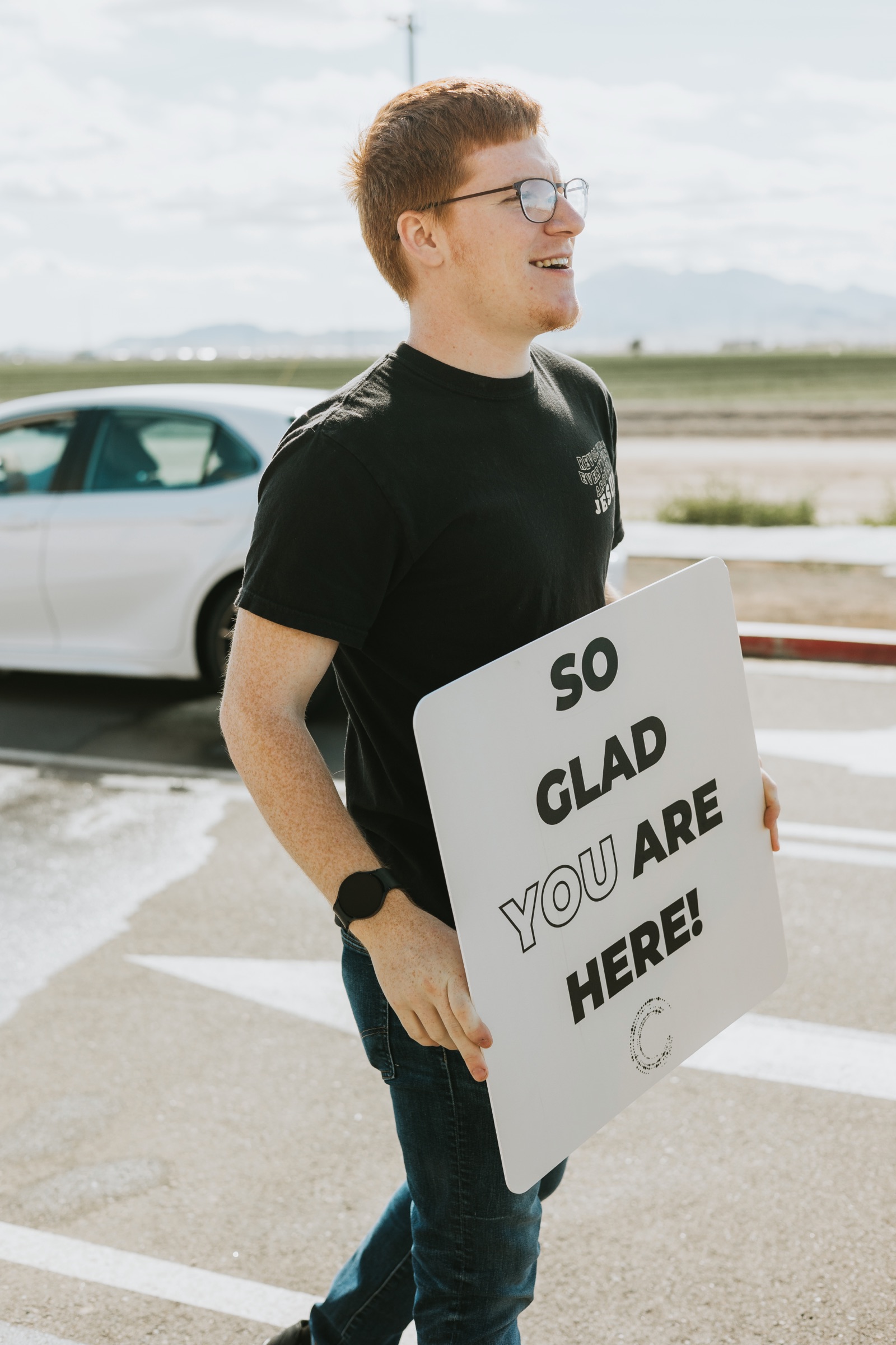 An Orbit volunteer welcoming guests outside the church